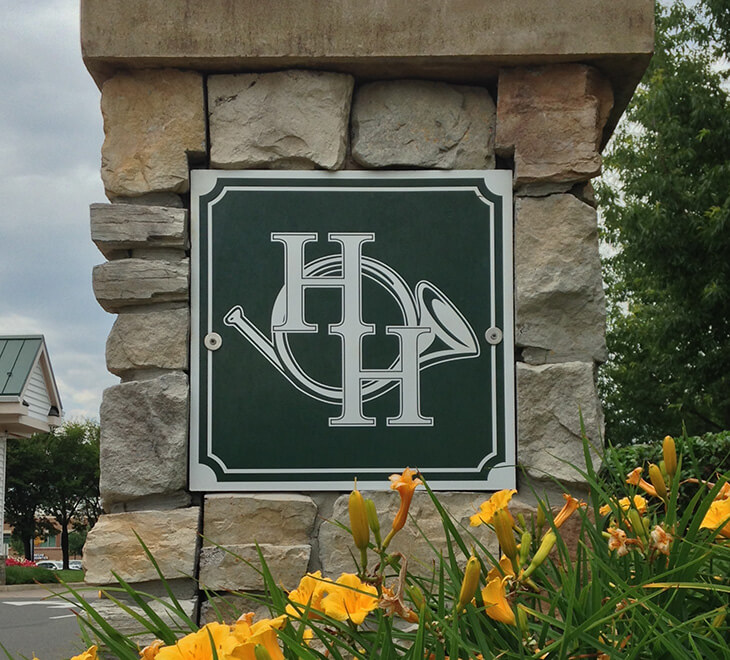 Heritage Hunt logo on stone pillar